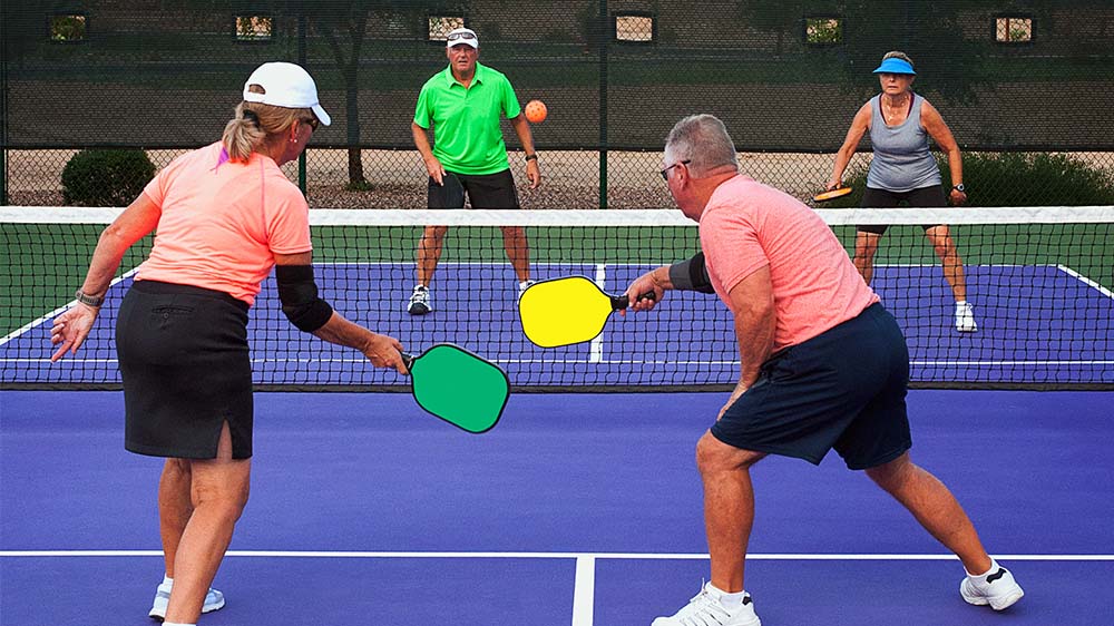 Two couples playing pickleball